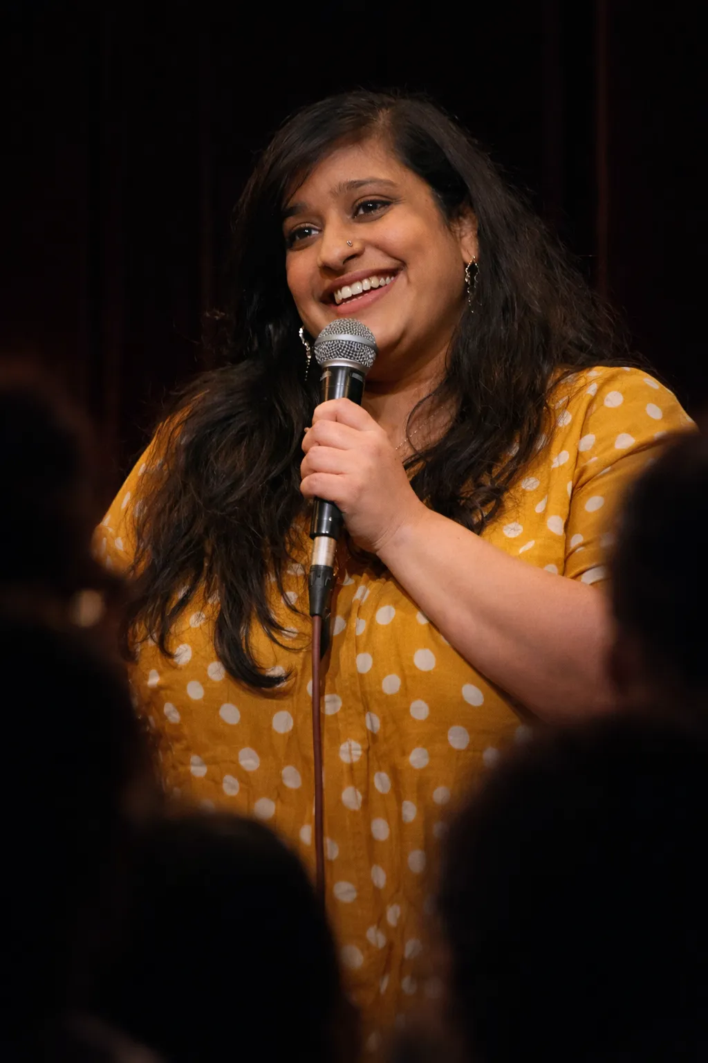 A singer with a disability performing with a microphone