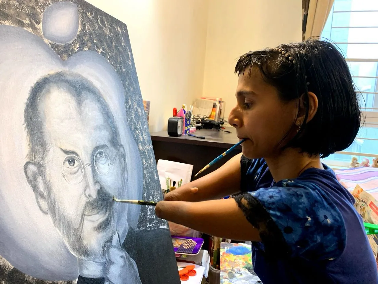 An artist painting a portrait holding the brush in her mouth